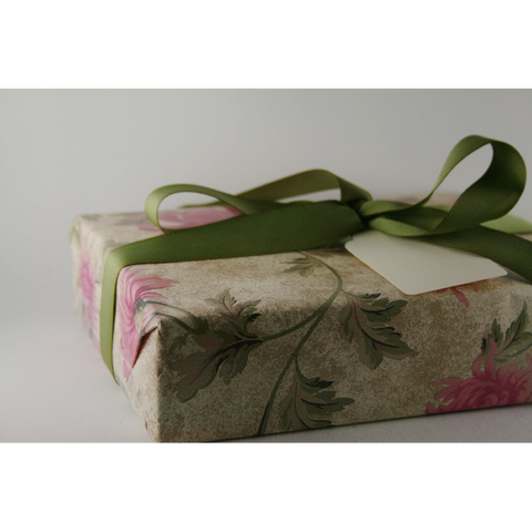 Luxury spa gift set gift wrapped with a green ribbon.