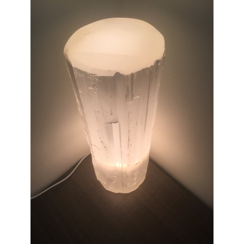 "Top view of the illuminated selenite lamp, displaying the texture and glow of the crystal."