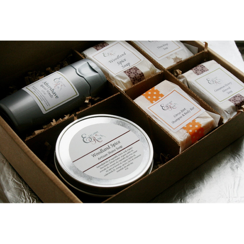 A well-organized gift box with manly sample soaps, full-size artisan shave soap, and a natural aftershave, tailored for men's grooming.