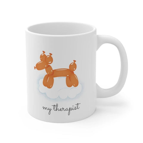 White mug featuring an orange balloon dog on a cloud with the text 'my therapist.'