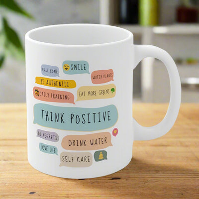 White ceramic mug with colorful positive affirmations.