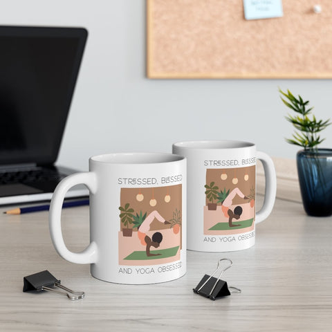 Two yoga mugs on an office desk.