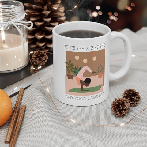 Yoga-themed mug with coffee, pinecones, and a cozy decor.