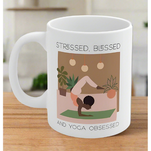 White ceramic mug with yoga pose and mindfulness design.