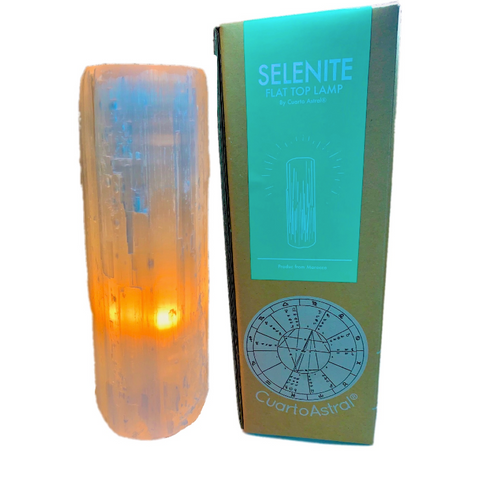 "Selenite crystal lamp with a warm, colorful background, showcasing its decorative appeal and the box that it comes in." 