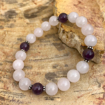 Close-up Rose Quartz and Amethyst stretch bracelet.